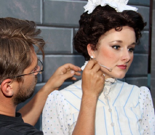 Jason Jensen makes a last minute adjustment to actress Delaney Westfall's mic element prior to taking the stage for Disney’s MARY POPPINS”.